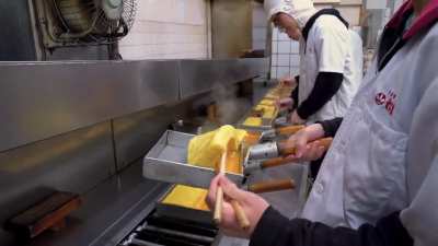 Flipping a Japanese rolled omelette. Looks simple but it took these guys 3 years to learn the technique. They could do this their whole life but they humbly admit there's no such thing as a perfect omelette.