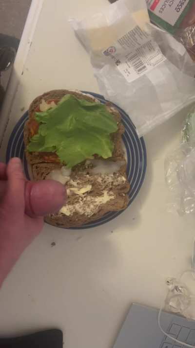 Adding some sauce to the sandwich I’m making