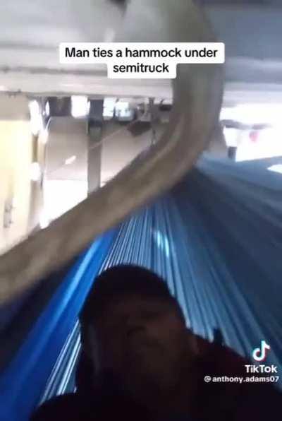 Man on Hammock under Semi