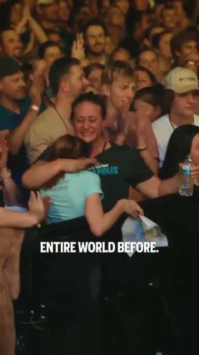 Macklemore, being a legend, hypes up a girl after she fell on stage