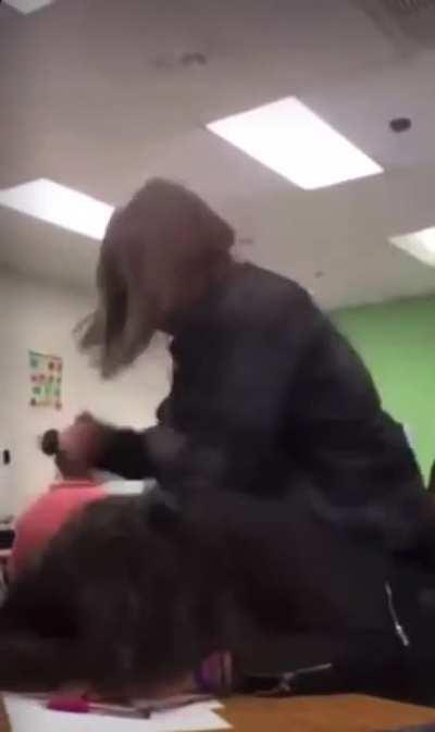 The girl beats her classmate