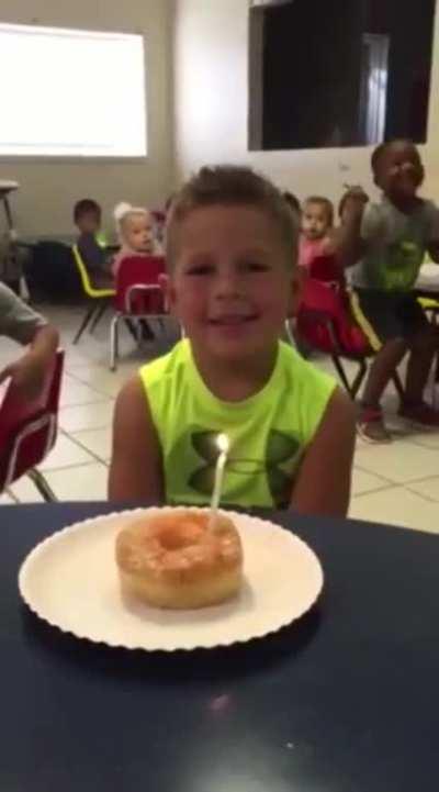 Kid getting excited over friend's birthday.