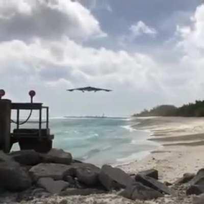 B2 Spirit coming in for a landing at a shoreline.