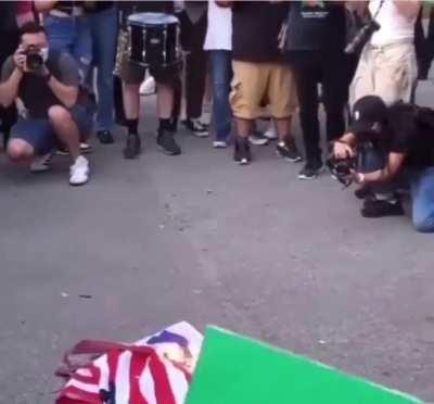 Burning American flag on Independence Day at a free Palestine protest in Brooklyn NY