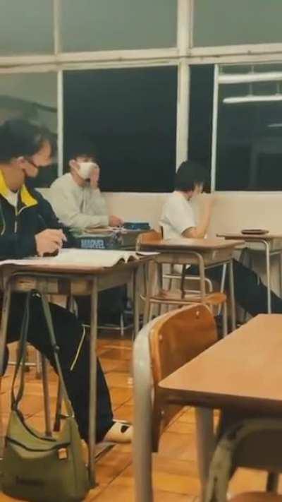 to lean casually against a window (in class)