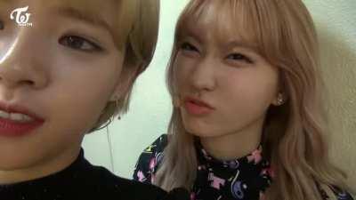 Momo making funny faces behind Jeongyeon
