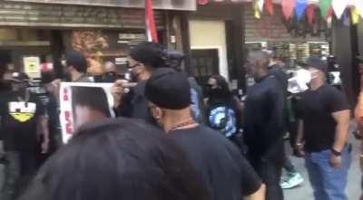 Group of protesters in NYC target businesses that choose to stay open on Malcolm X birthday. They pressure an Asian American man to close his business