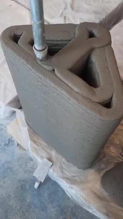 3D printing a section of a modular post-tensioned beam.