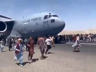 People hanging on to a USAF Aircraft while it's taking off