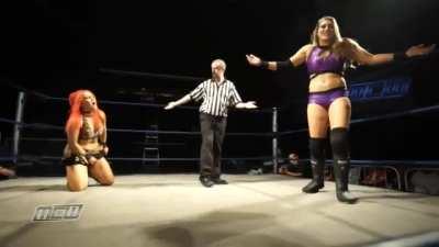 Rhea fires a powerful kick between the legs of Kellyanne