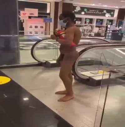 Naked guy at the Mall gets whacked by a dude who's seen enough dick & ass for the day.