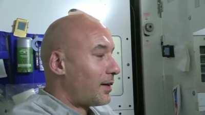 ISS Astronaut washing his bald head in space.