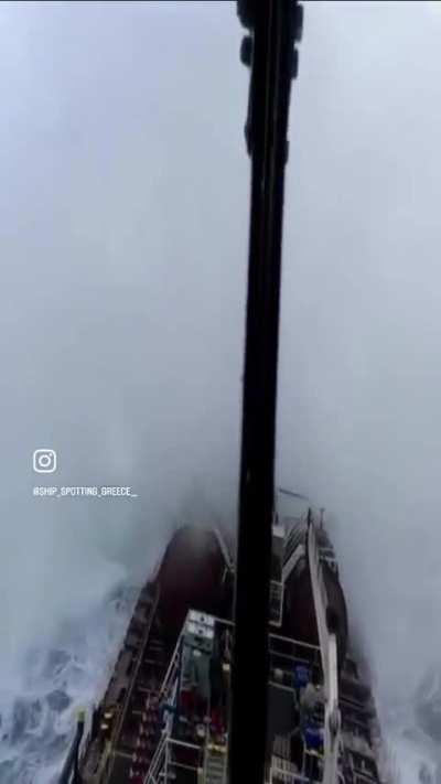 Ship going through massive wave 