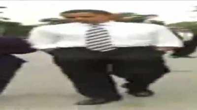 Wide Barack Obama walking but he's always dancing