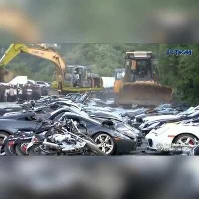 Over $8 million dollars worth of cars crushed publicly in Philippines to deter illegal imports.