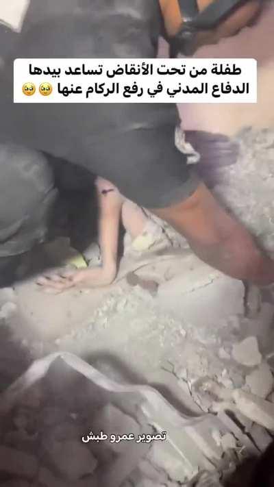 A Palestinian girl shows her unmatched resolve to survive as she helps rescuers dig her out of the rubble from an IDF airstrike