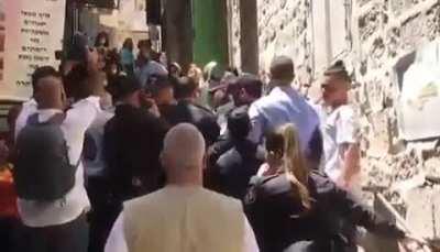 israeli occupiers police assault Christian Palestinians and several nuns, block them from entering the Church of the Holy Sepulcher for the Sabbath