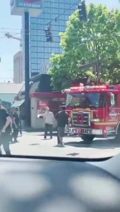 A vigilante comes to the rescue, preventing a main character from obstructing a fire truck.