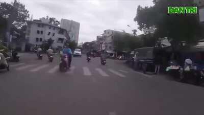 Vietnamese undercover cop high-speed chasing criminal on motorbike in busy traffic