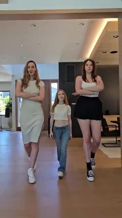 The taller girls are 6'7 the one in the middle is about 4'10

