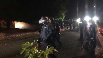 Portland protesters deter Police with a shield phalanx.
