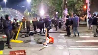 In seattle Antifa attempts to murder a police officer hitting him in the head with a metal bat.