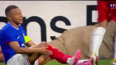 Mbappe watches the man from a ad