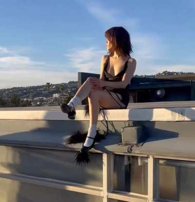 Jenna Ortega posing in a black dress