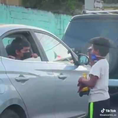 Heartwarming moment as a kid selling snacks in the streets to help his family meets another kind kid with a good heart
