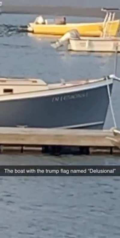 Fishing boat named “Delusional” flying the Trump flag