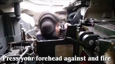 Kid learning how to shoot a tank from his dad