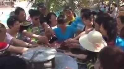 Chinese Tourists vs a plate of fruits and shrimp