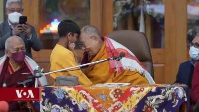 Why did the Dalai Lama kiss this young boy on the lips then tell him to 