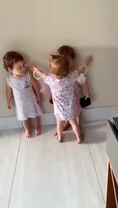 Three little humans talking effusively in their own language