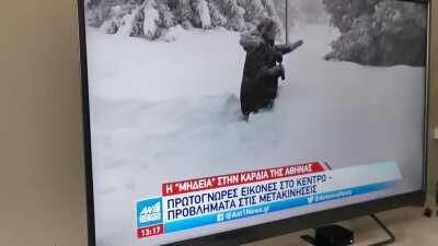 Reporter is exaggerating the amount of snow by walking on his knees, but cameraman picks the wrong angle.