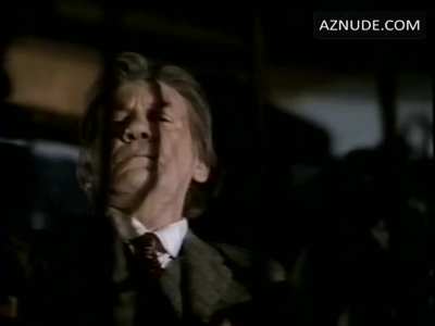 Pamela Anderson gets her bare breast fondled while she makes out with a guy in 