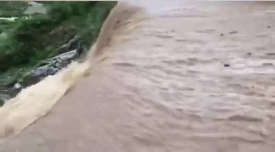 Man attempts to run across stream, meets waterfall