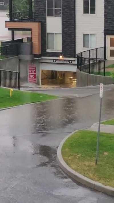 Flash flood ripped open the garage door to the parkade and it's been rushing in like this for an hour.