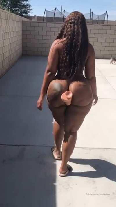 Casually walking with a dildo in between her butt cheeks