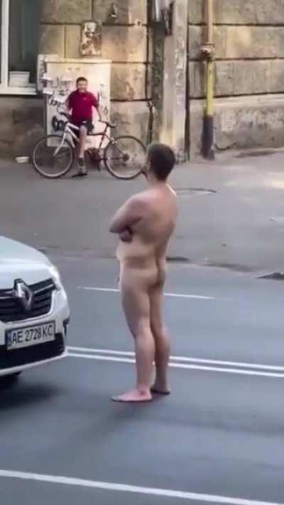 Guy stands in the street naked blocking traffic and then...