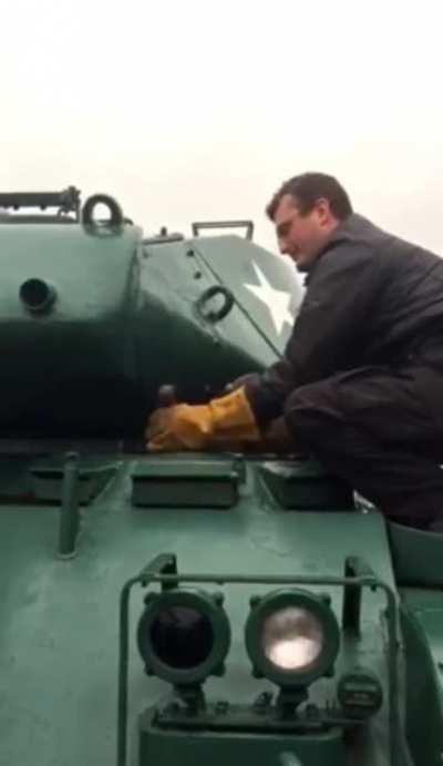 Chonky trash panda gets stuck in tank