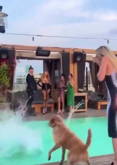 Two women dancing by the pool. 