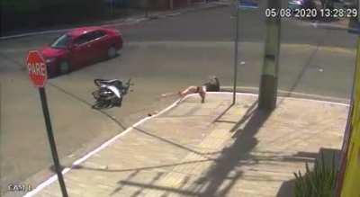 Biker crashes into car and falls into sewage