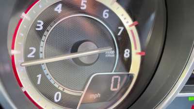 What could be the cause of the knocking noise after revving the engine