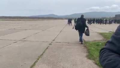 Ru pov: in far East of Russia, mobilization is underway. One recruit is seen stumbling around and another fell asleep in the bushes