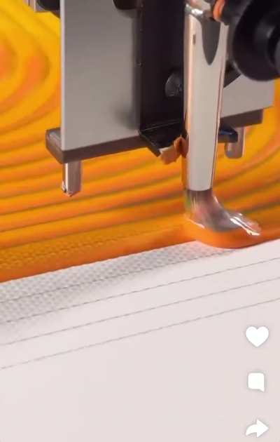 Machine painting on a path with a paint brush.