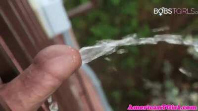 Peeing off a balcony and on her feet