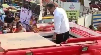 Kamal shouting and throwing his party symbol heavyweight torch light on his party worker.