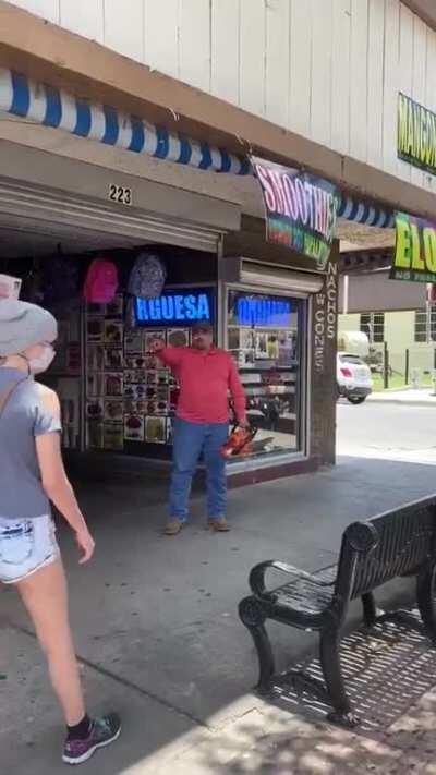 Man with chainsaw tells protesters to 