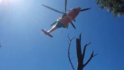 Ambulance Victoria's AW139 HEMS 4 performing a rescue atop a mountain